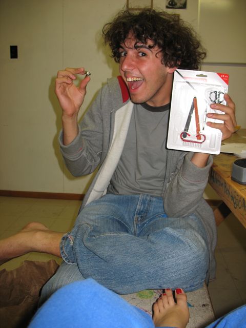 Me clipping my nails on a porch with my newly purchased nail-clipping set