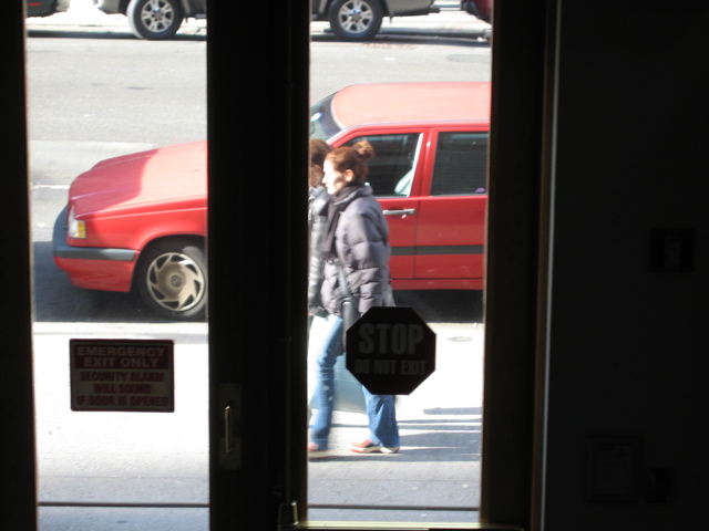 A woman with her hair in a bun and another woman with a shopping bag