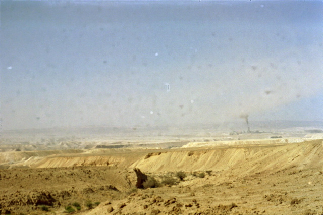 A factory pollutes the desert air