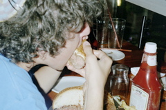 Nathan eating a quarter of his Sumoburger