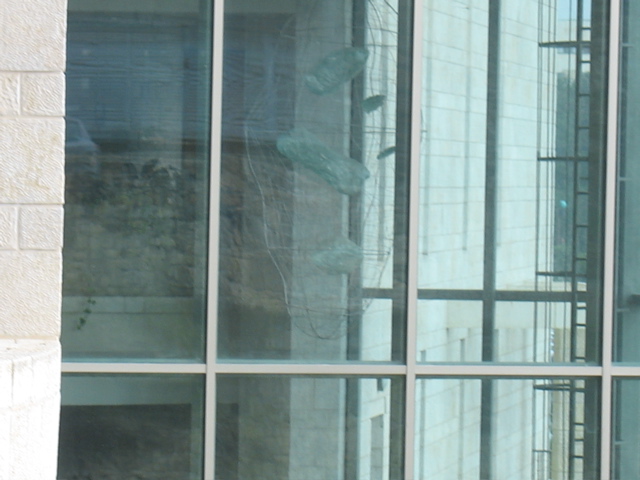 A hanging sculpture inside a building far away
