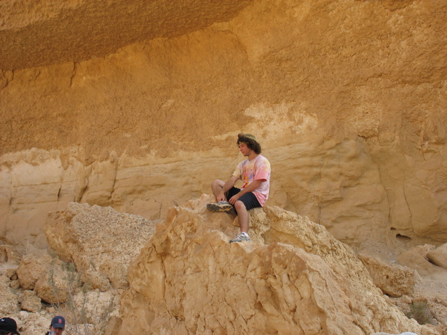 Josh sits perched atop a boulder