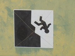 Man falling off cliff sign