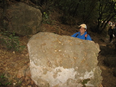 Julia hides behind a rock