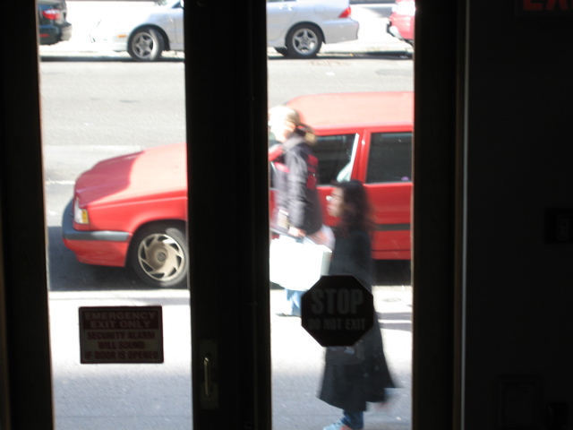 Two women go south (foreground); A car begins pulling out (background)