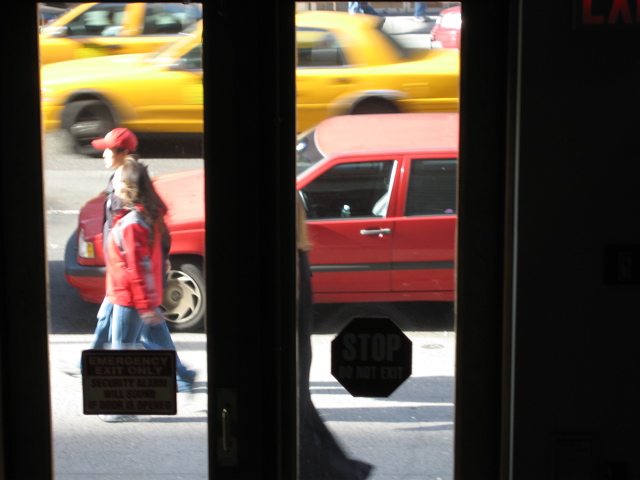 A couple, and a woman in a long black coat; two cabs