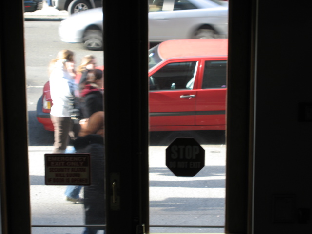 Four people; A silver car