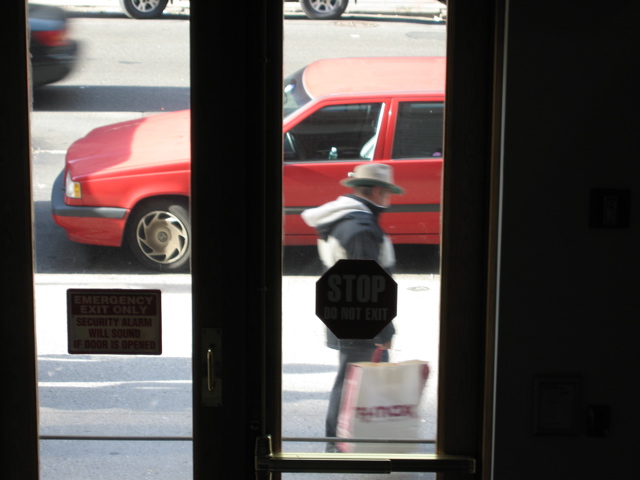 The man with the TJ Maxx bag; the tail end of another car