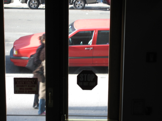 A woman with a black bag and a woman with red shoes