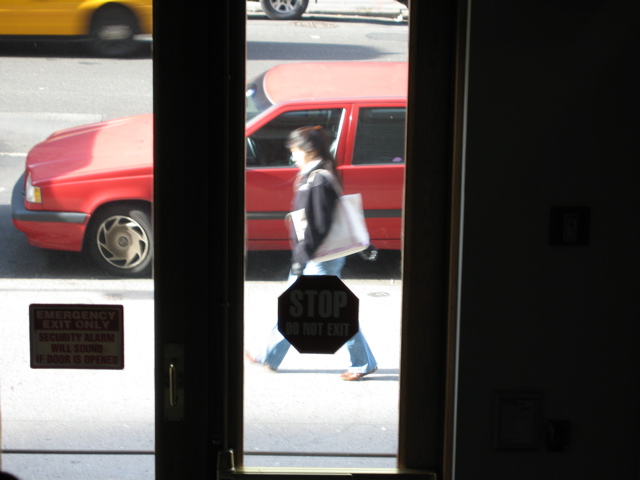 A woman with a shopping bag; a cab