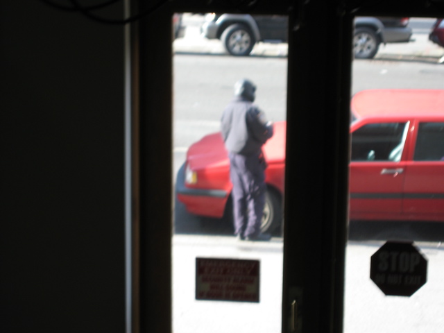 The policeman writes a ticket for the car