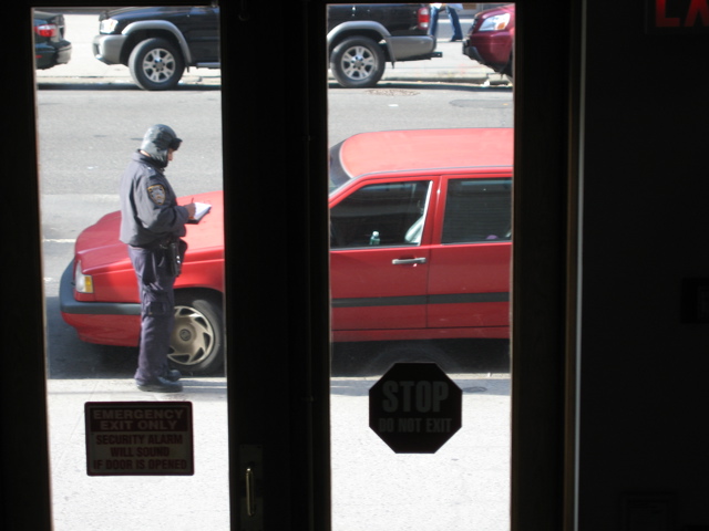 Policeman writes a parking ticket