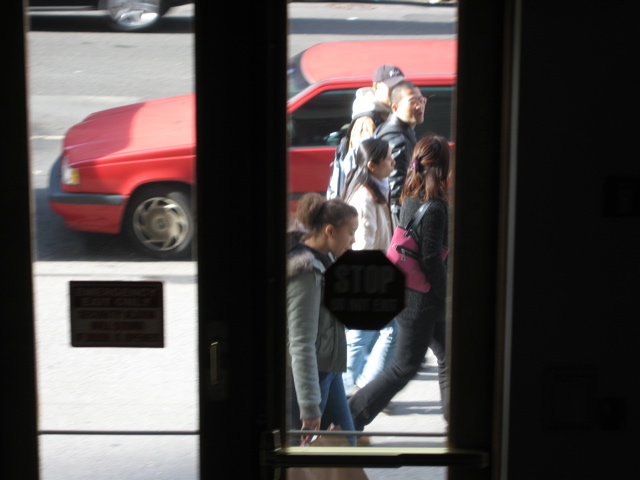Five people walk by as the SUV leaves