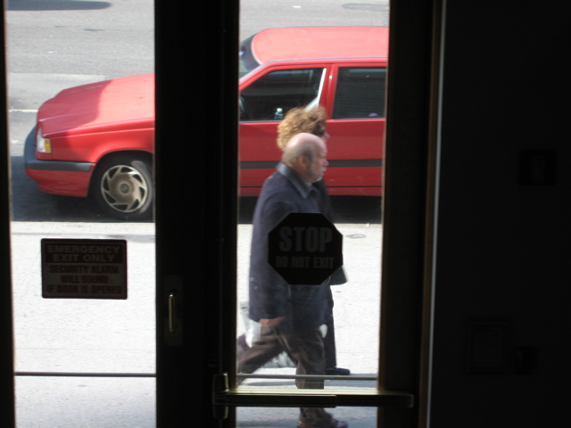 An elderly couple walks by