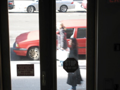 Two women go south (foreground); A car begins pulling out (background)