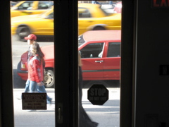 A couple, and a woman in a long black coat; two cabs
