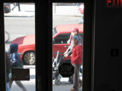 Two women, one with a hoodie, and a couple with a stroller