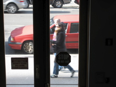 Two girls; An automobile goes by; an SUV has taken the open background parking spot