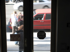 Four people; A silver car