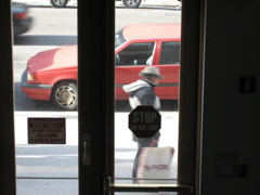 The man with the TJ Maxx bag; the tail end of another car