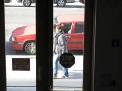 A woman with her hair in a bun and another woman with a shopping bag