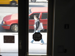 A woman with a shopping bag; a cab