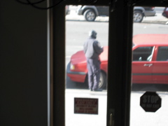 The policeman writes a ticket for the car