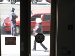 A woman rushes past the policeman