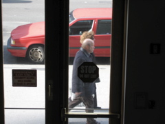 An elderly couple walks by
